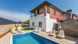 A two-story house with a swimming pool, white and red exterior, and a stone chimney. - Stunning home in Pula (Pula)
