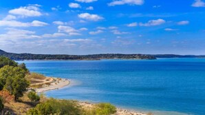 Eine Küstenlandschaft mit blauem Himmel, Sandstrand und ruhiger See.