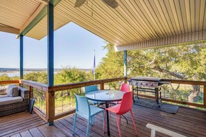 A covered outdoor deck with a table and chairs, a grill, and a view of the landscape. - 4/3, hot tub, Lake Views, private lot (Canyon Lake)