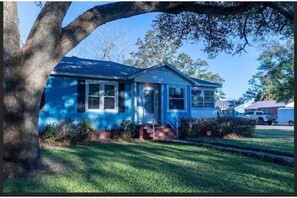 Stunning home with a front porch and beautifully manicured lawn.