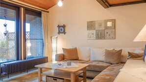 A cozy living room with a sofa, a coffee table, and a large window. - Awesome home in Meschede with WiFi (Meschede)