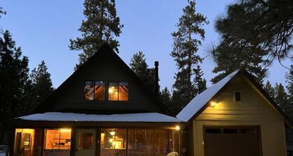Wooden A-Frame Cabin Nestled in the Tall Pines