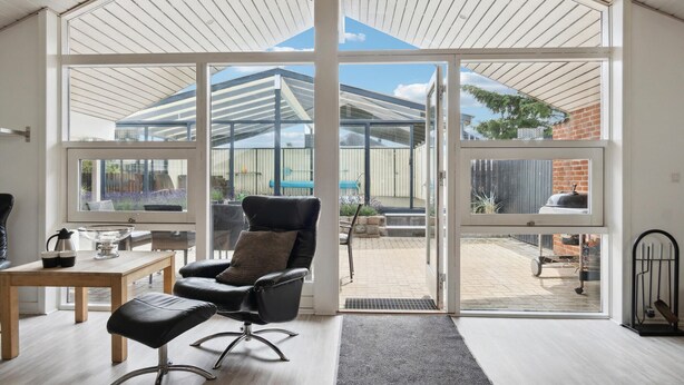 A modern interior with a large sliding glass door leading to a backyard.