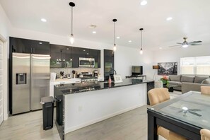 Enjoy cooking in this well-equipped kitchen with a sleek island and stainless steel appliances.
