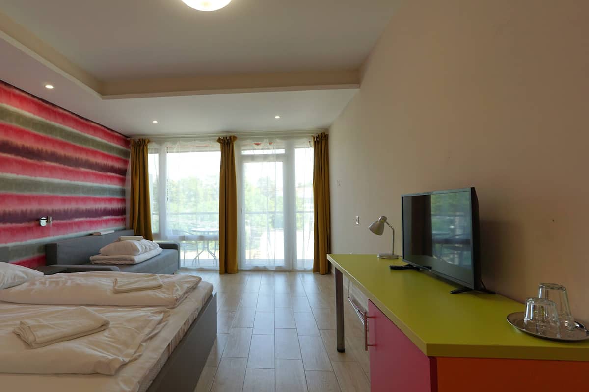 Comfort Quadruple Room | Minibar, in-room safe, desk, iron/ironing board