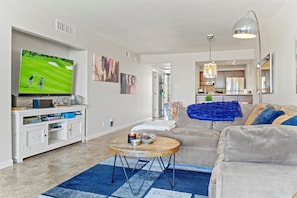 A modern living room with a television, sofa, and coffee table.