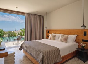 A bedroom with a large bed, a view of the ocean, and a balcony with a chair. - Nous Santorini (Santorini)