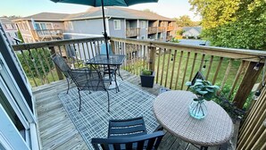 A deck with a table and chairs, a potted plant, and a hanging umbrella. - POOL, PARKING, 2BR 2 BA, walk to town! (Rehoboth Beach)