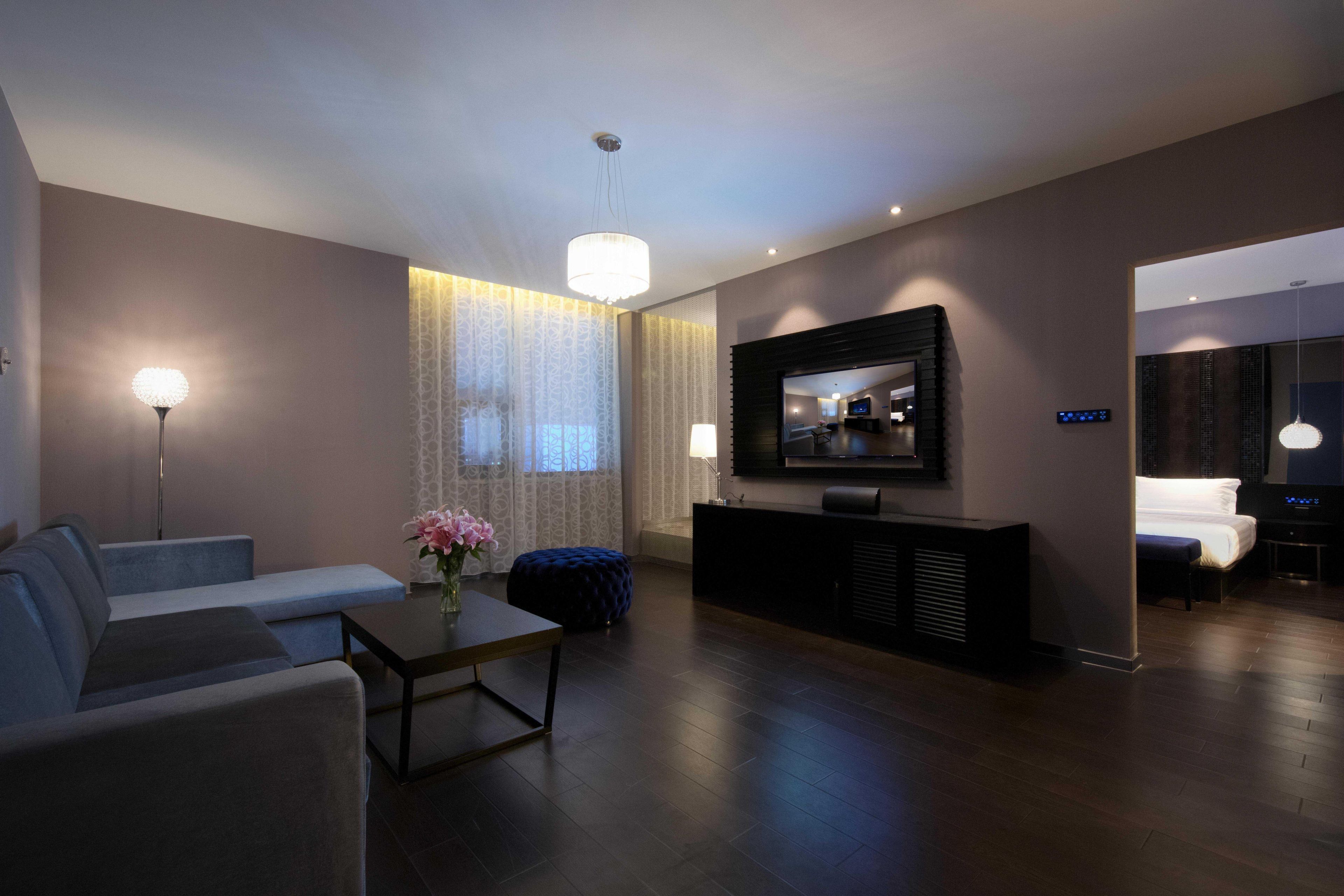 A modern living room with a sofa, a coffee table, a TV, and a console table.