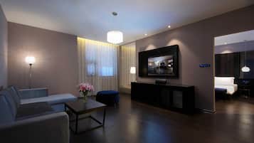 A modern living room with a sofa, a coffee table, a TV, and a console table.