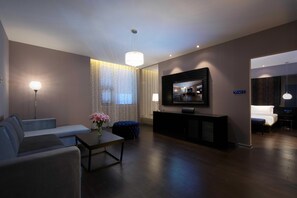 A modern living room with a sofa, a coffee table, a TV, and a console table.