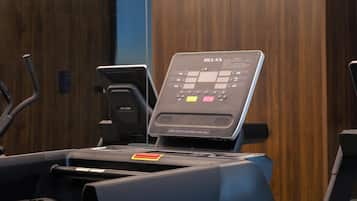 A treadmill with a control panel, a water bottle holder, and a wooden wall in the background.