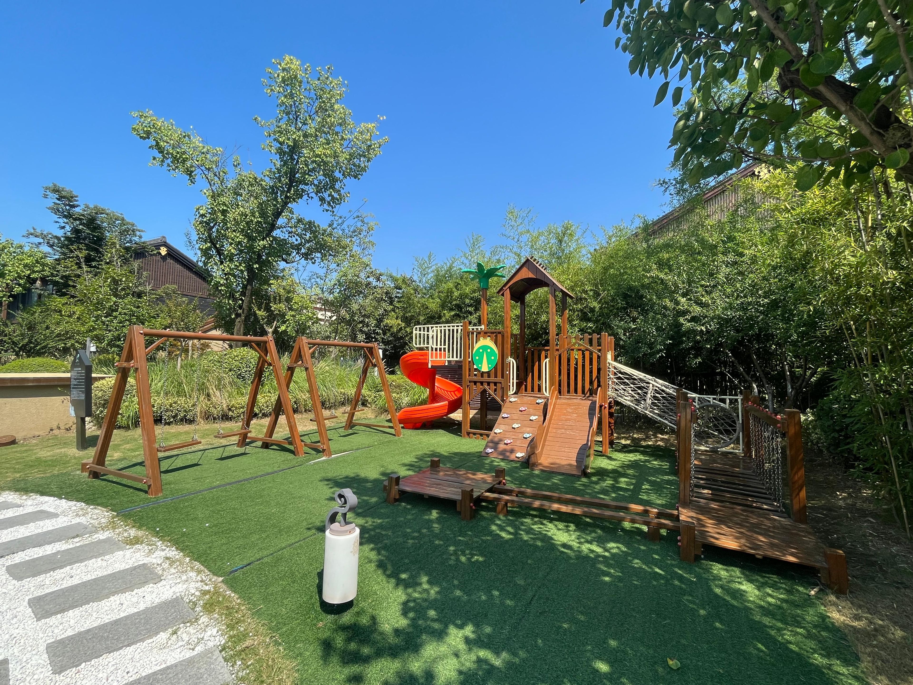 A playground with swings, slides, and a climbing structure.