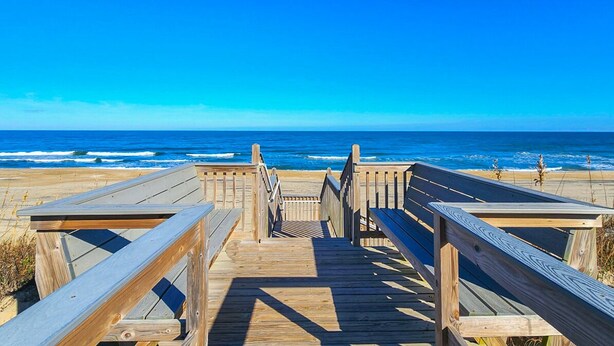 A wooden boardwalk leading to the beach with a clear view of the ocean. - C'EST FINI - Enjoy superb ocean views & great beach access from this 4,000 plus sqft. stunning home! (Southern Shores)