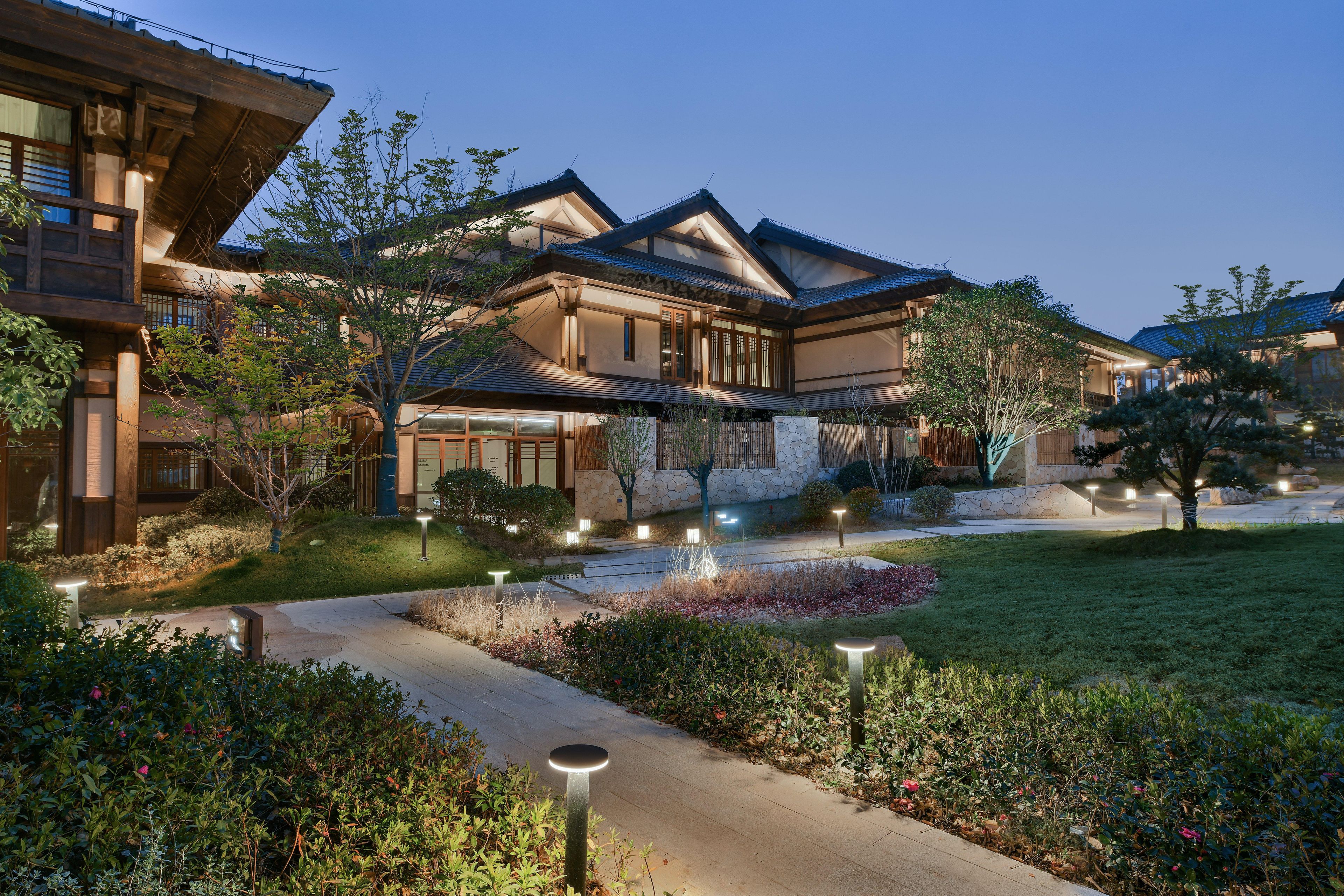 A traditional Japanese-style building with a stone facade, wooden beams, and a sloped roof.
