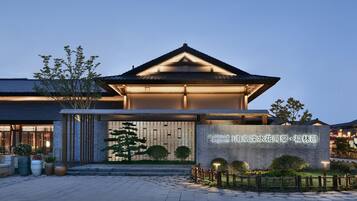 A traditional-style building with a prominent entrance and a signboard.