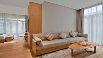 A modern living room with a sofa, a coffee table, and a desk.