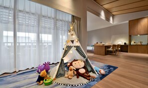 A cozy room with a play tent, plush toys, and a small table. - Blossom Hill Hotel Nanjing Lishui (Nanjing)