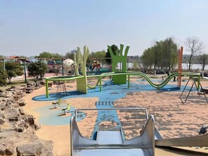 A playground with slides, swings, and climbing structures. - Blossom Hill Hotel Nanjing Lishui (Nanjing)