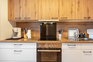 Een koelkast, een oven, een kookplaat, een vaatwasser