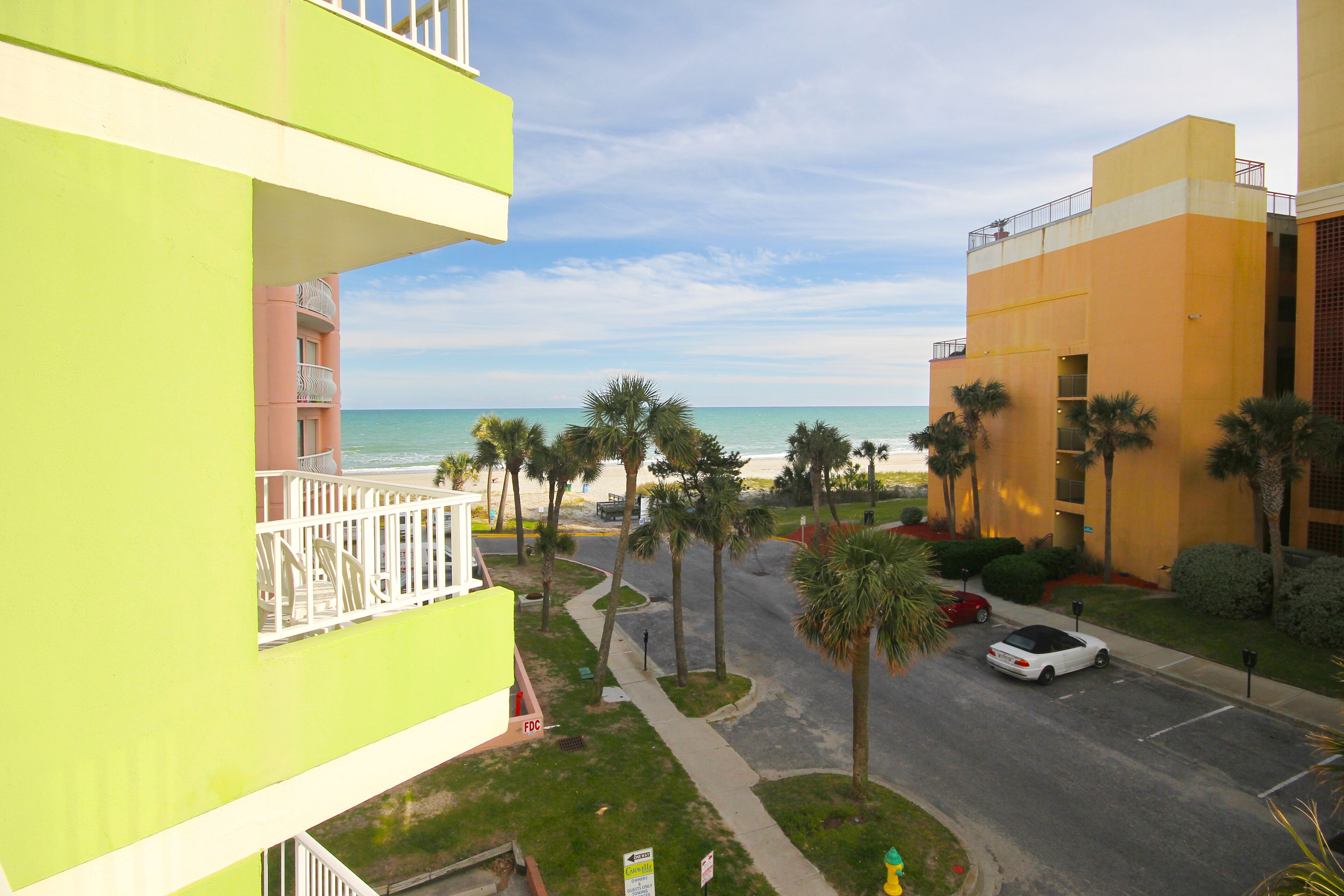 Dog-friendly beachfront studio with partial ocean view, private balcony, & pool