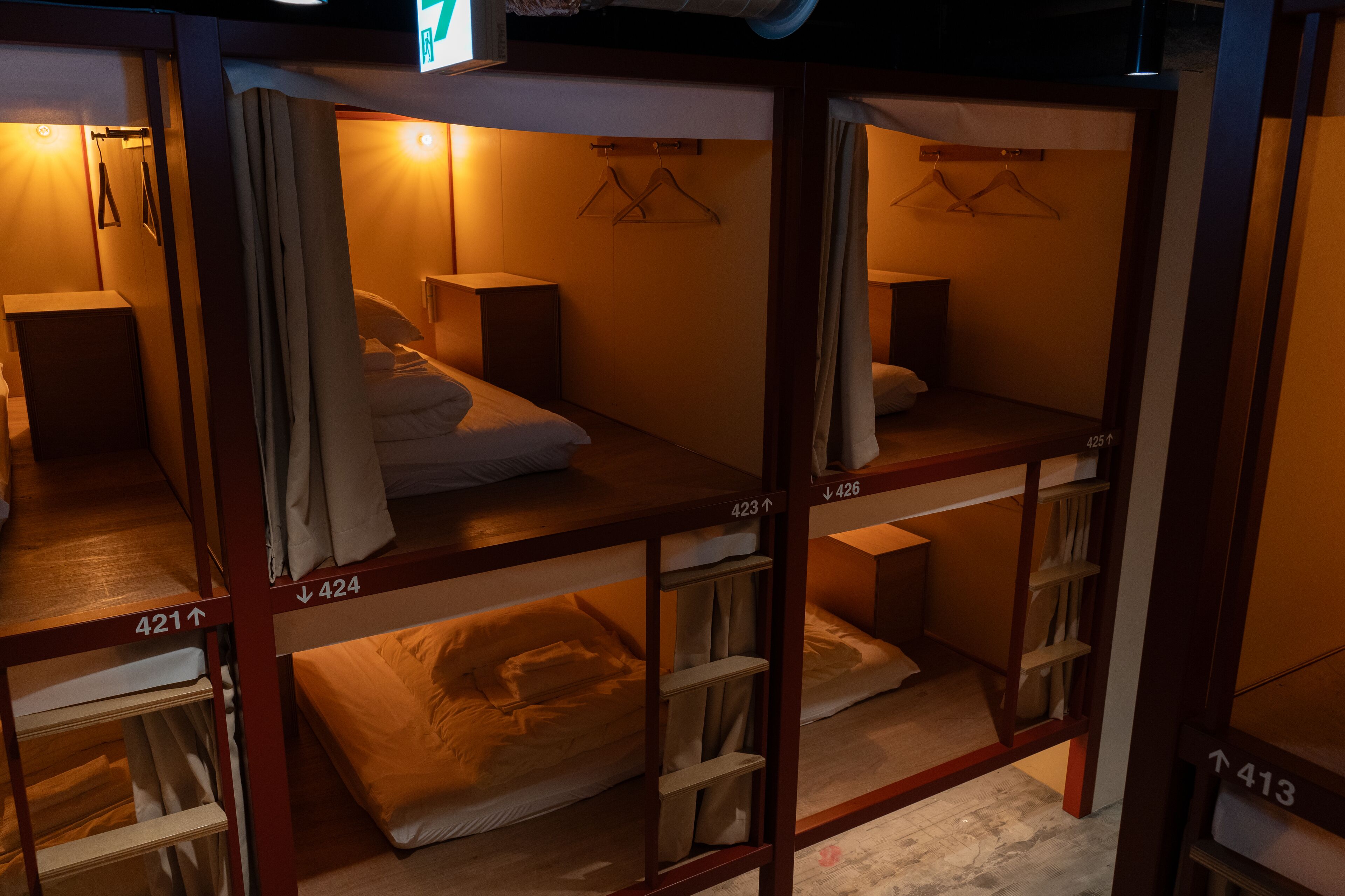 A hotel room with bunk beds, each bed marked with a number.