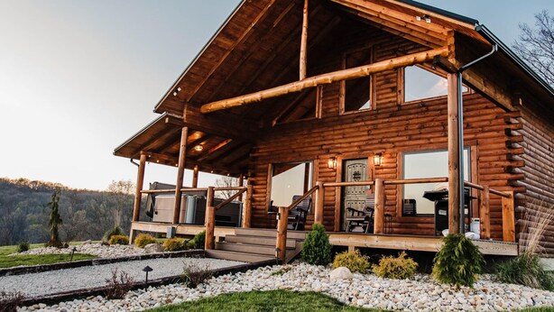 A log cabin with a porch, outdoor seating, and a view of the surrounding landscape. - Stunning Hocking Hills Views, Huge Skies ~ Sauna, Pet Friendly, Hot Tub, WiFi (new plymouth)