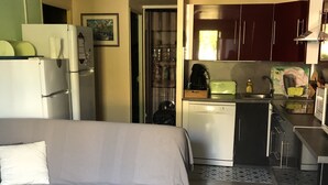 A compact hotel room with a bed, a kitchenette, and a small bathroom. - Rent House in Residence (Argelès-sur-Mer)