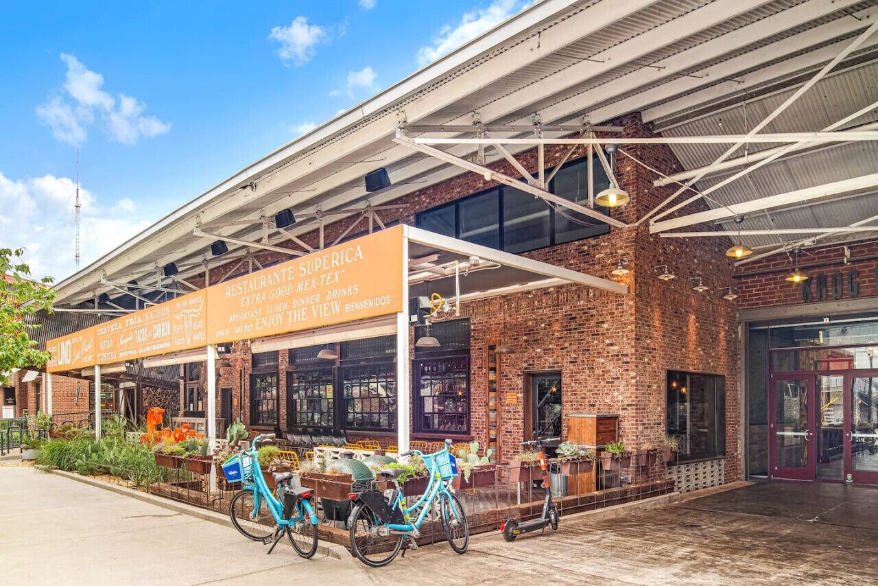 A restaurant with a signboard advertising various dining options and a bike parked outside.