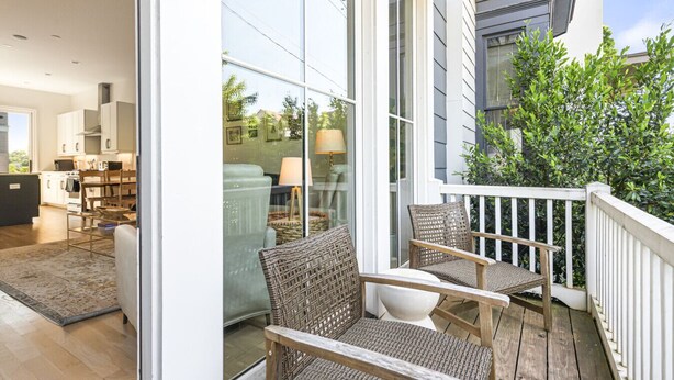 A modern kitchen with white cabinets and a dining area with a table and chairs. - Second Floor Balcony | EV Charger |King Bed (Atlanta)