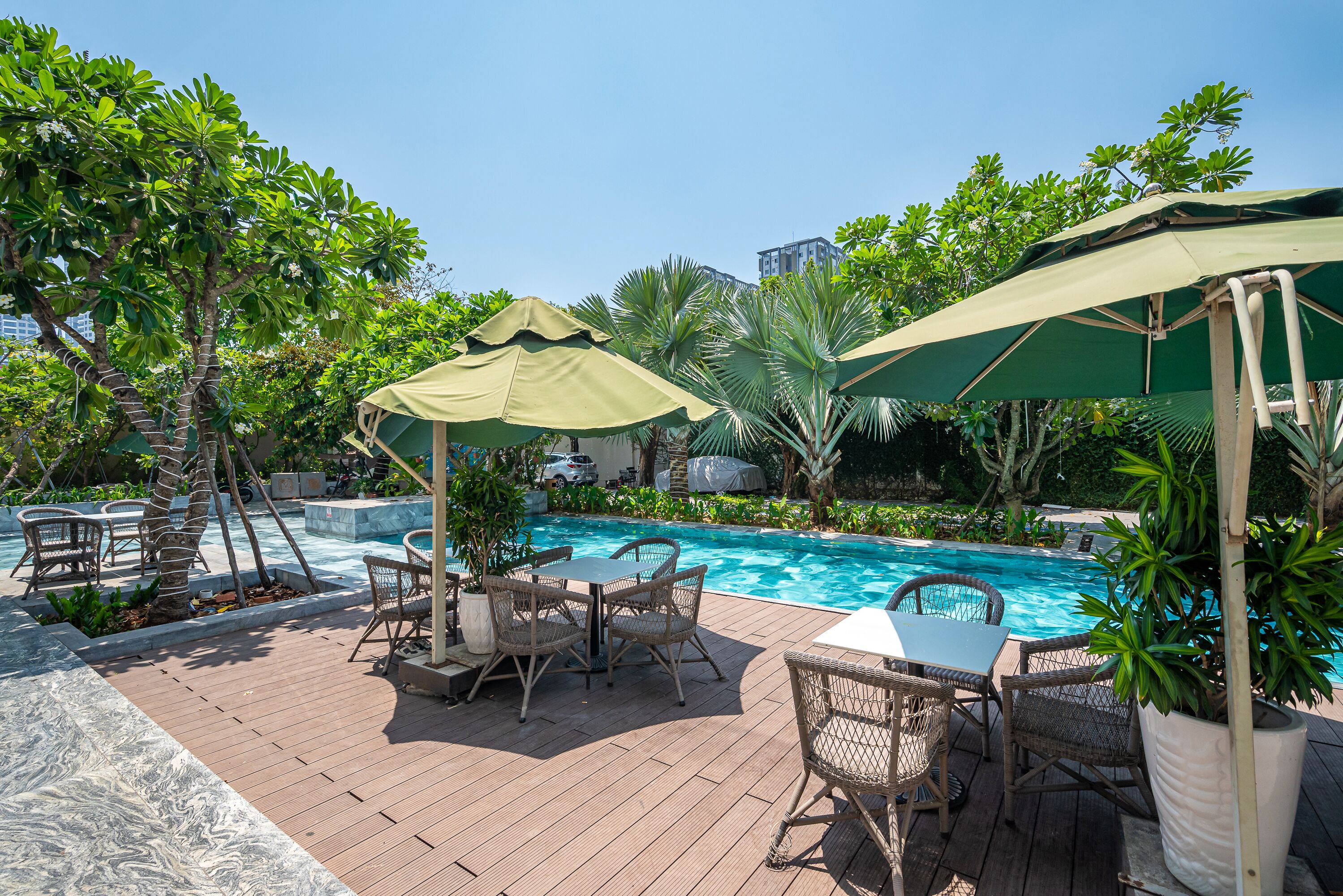 A poolside area with outdoor seating and umbrellas.