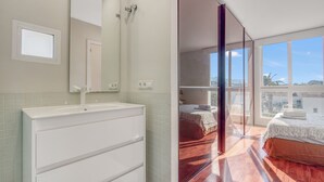 A modern bathroom with a large mirror, a white sink, and a tiled wall. - Villa 'Traviata ' with Sea View, Private Pool, Wi-Fi and Air Conditioning (Benissa(Alicante))