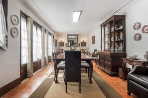 A dining room with a long table, chairs, a cabinet, and a mirror. - Casa do Terreiro with private pool, private terrace, and Wi-Fi (Barqueiros)