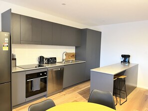 Enjoy cooking in this well-equipped kitchen with oven, dishwasher, and coffee machine.