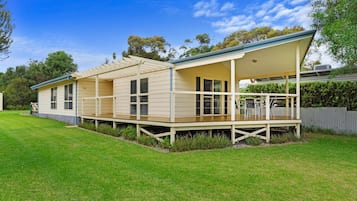 A single-story house with a covered porch and a fenced yard.
