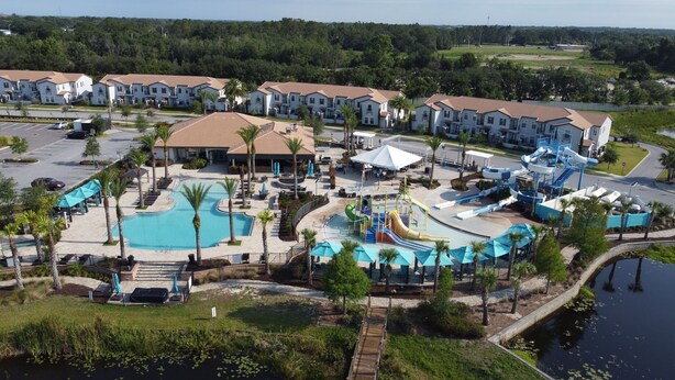 A resort with multiple buildings, a swimming pool, and a water park. - Beautiful 4 Bedroom Home With Pool Overlooking Lake Views (Haines city)