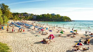 A crowded beach with numerous umbrellas and people. - Neptuna Kata Hotel (Karon)