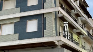 A multi-story building with a modern architectural design, featuring balconies and large windows. - B&B CENTRALE (Gela)