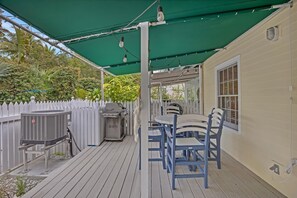 Enjoy dining and socializing under the shaded patio, complete with a grill and air conditioning for a comfortable outdoor experience.