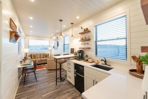 Fridge, microwave, coffee/tea maker, cookware/dishes/utensils
