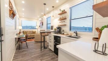 Fridge, microwave, coffee/tea maker, cookware/dishes/utensils