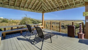 A wooden deck with two chairs and a bench, overlooking a beach and dunes. - Sunset Rentals | Island Club 114 (Hilton Head Island)