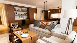 A modern living room with a sofa, coffee table, and a bookshelf. - Mountain Modern 3 Bedroom Deluxe Condo, Sleeps 10 by RedAwning (Park City)