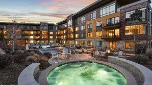 A modern hotel with a heated outdoor pool, lounge chairs, and a well-lit courtyard. - Mountain Modern 3 Bedroom Deluxe Condo, Sleeps 10 by RedAwning (Park City)
