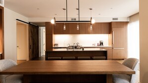 A modern kitchen with a central island, pendant lights, and wooden cabinetry. - Mountain Modern 3 Bedroom Deluxe Condo, Sleeps 10 by RedAwning (Park City)