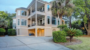 A multi-story house with a balcony, a garage, and a driveway. - 12 Port Tack -  4 min walk to the ocean.  Views of golf, lagoons & sunset (Hilton Head Island)