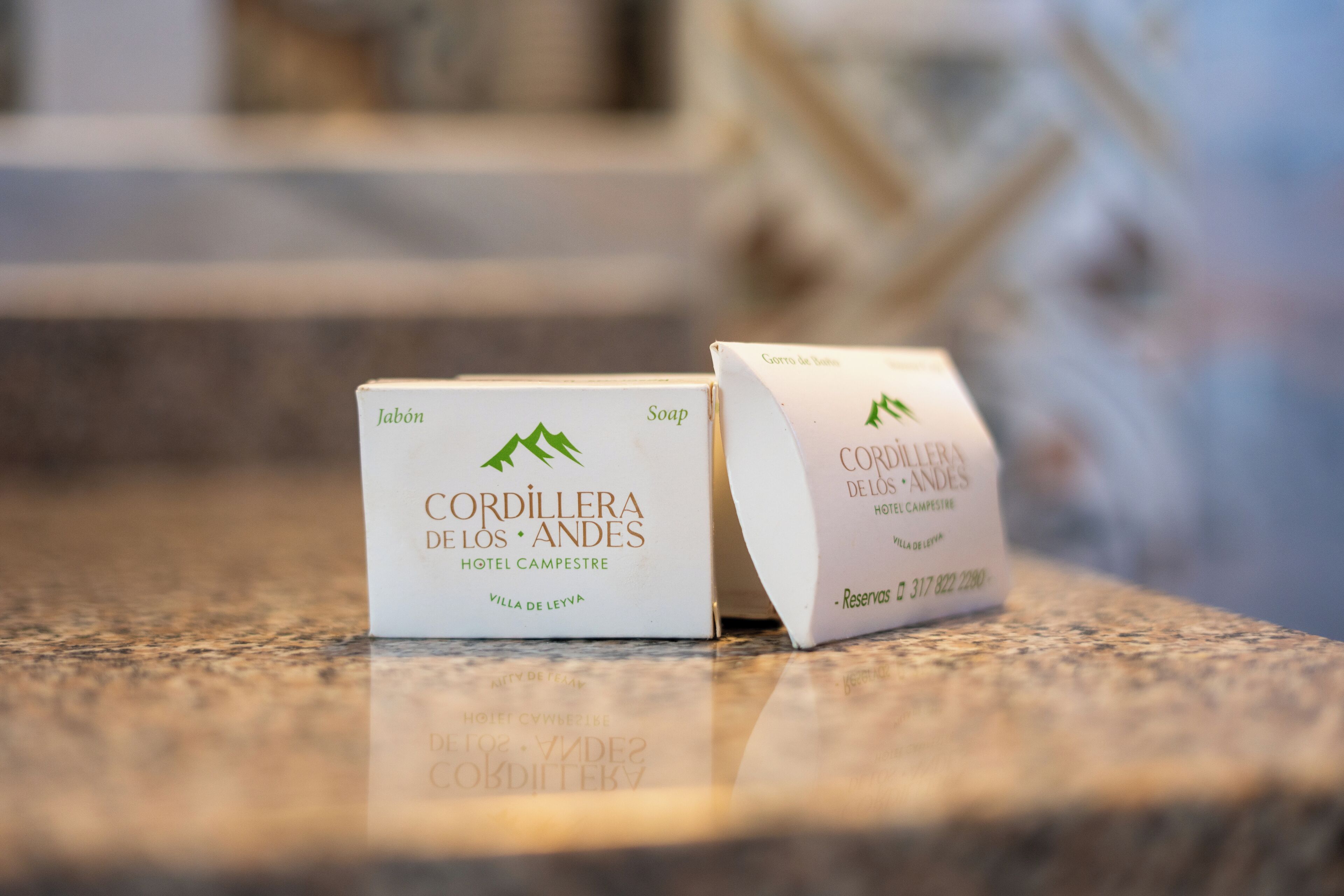 Two white boxes with text and a mountain logo, placed on a granite countertop.