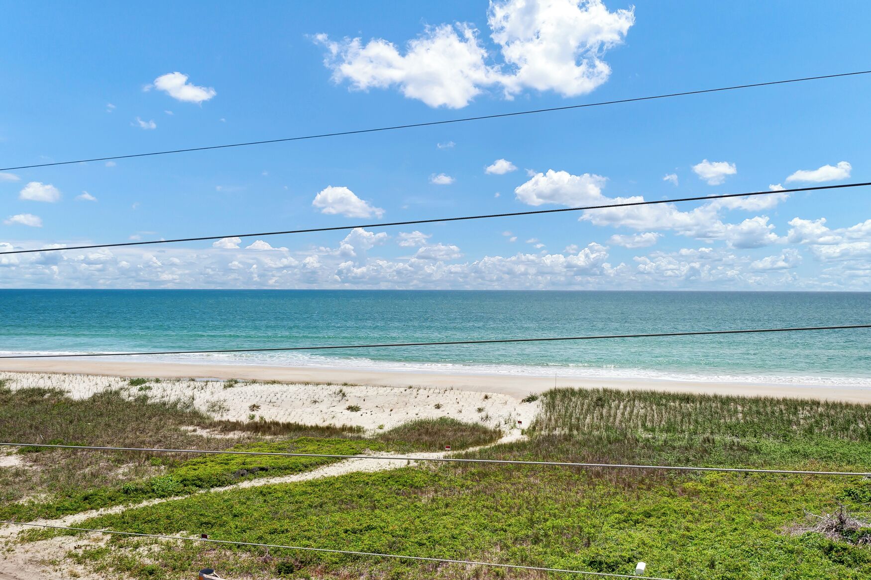 A beach with clear skies and calm waters.