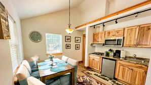 A compact kitchen with wooden cabinets, a microwave, and a sink.