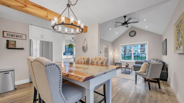 A modern kitchen with a wooden island, stainless steel appliances, and a chandelier. - A bright & chic 2 bedroom urban apartment (Orangeville)